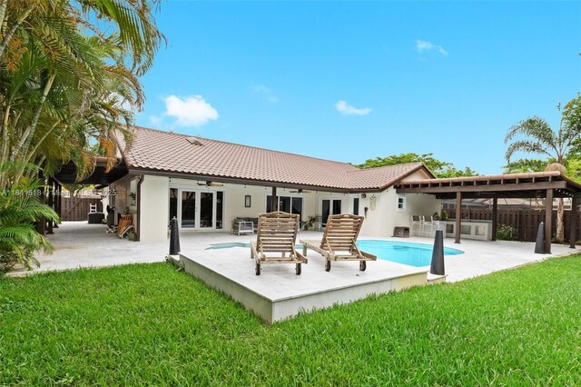 875 NW 108th Ln, Coral Springs, FL 33071 - rear view of house with a ceiling fan, french doors, a tile roof, a patio, and an outdoor pool