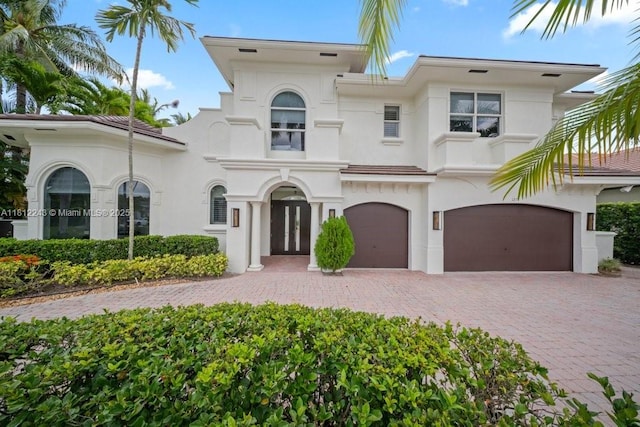 127 Swan Ave, Plantation, FL 33324 - view of front of home with stucco siding, a garage, and decorative driveway