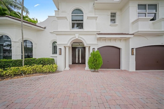 127 Swan Ave, Plantation, FL 33324 - view of front of property with a garage, decorative driveway, stucco siding, and french doors