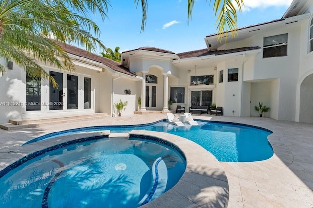 127 Swan Ave, Plantation, FL 33324 - view of swimming pool with french doors, a pool with connected hot tub, and a patio