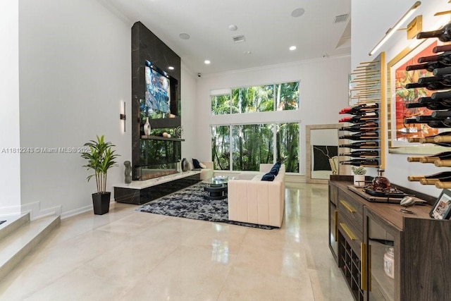 127 Swan Ave, Plantation, FL 33324 - tiled living room with a towering ceiling, ornamental molding, and recessed lighting