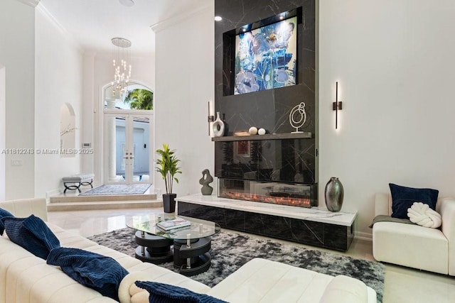 127 Swan Ave, Plantation, FL 33324 - living room featuring ornamental molding, a chandelier, and french doors