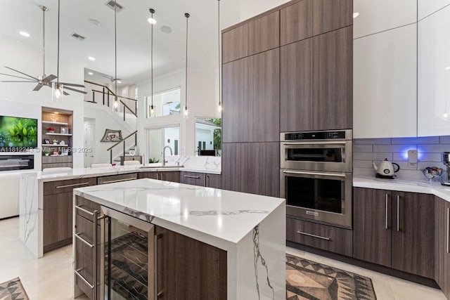 127 Swan Ave, Plantation, FL 33324 - kitchen featuring wine cooler, modern cabinets, double oven, a peninsula, and recessed lighting
