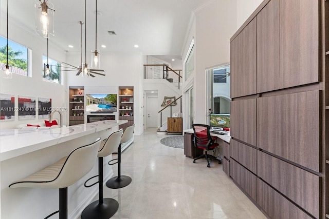127 Swan Ave, Plantation, FL 33324 - kitchen with a high ceiling, modern cabinets, a kitchen bar, an office area, and open floor plan