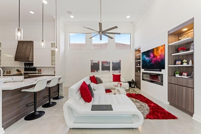 127 Swan Ave, Plantation, FL 33324 - living room with ornamental molding, ceiling fan, built in shelves, recessed lighting, and baseboards
