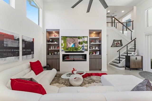 127 Swan Ave, Plantation, FL 33324 - living room with a high ceiling, stairs, healthy amount of natural light, built in shelves, and recessed lighting