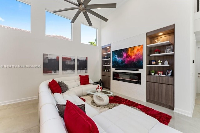 127 Swan Ave, Plantation, FL 33324 - living area featuring ceiling fan, built in shelves, a high ceiling, baseboards, and a fireplace