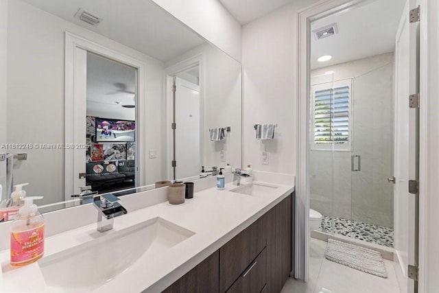 127 Swan Ave, Plantation, FL 33324 - bathroom featuring a stall shower, double vanity, toilet, and tile patterned floors