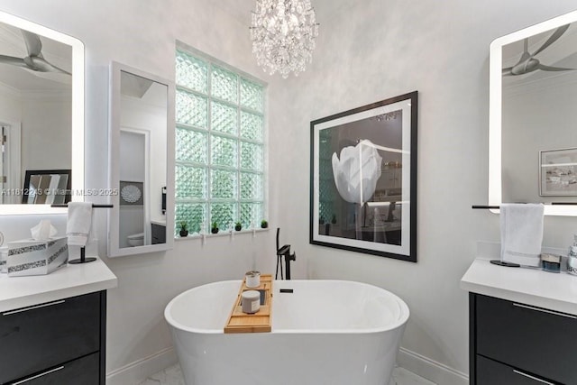 127 Swan Ave, Plantation, FL 33324 - bathroom featuring baseboards, vanity, a freestanding tub, and crown molding