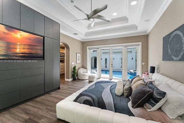 127 Swan Ave, Plantation, FL 33324 - bedroom featuring dark wood-style flooring, arched walkways, access to outside, crown molding, and a tray ceiling