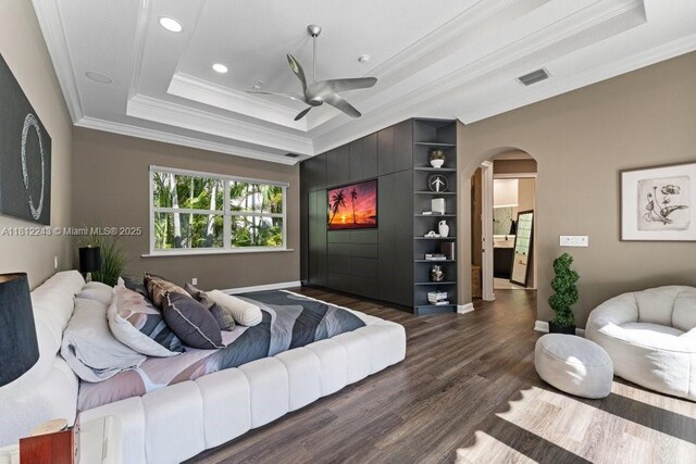 127 Swan Ave, Plantation, FL 33324 - bedroom with crown molding, a raised ceiling, arched walkways, dark wood-style flooring, and recessed lighting