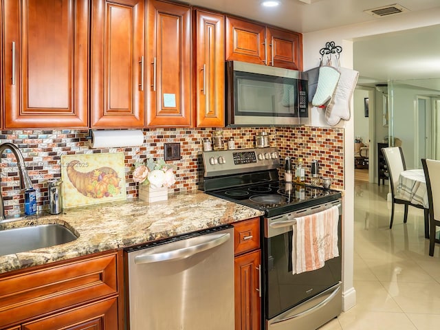 7850 W Mcnab Rd Unit 212, Tamarac, FL 33321 - kitchen with appliances with stainless steel finishes, light tile patterned floors, light stone counters, and tasteful backsplash