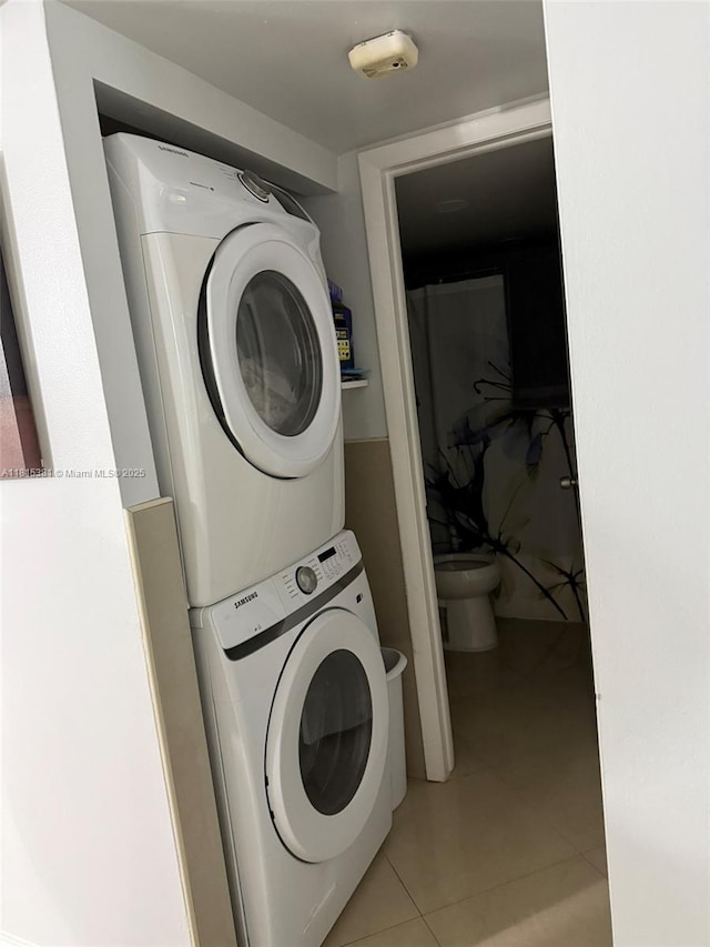 7850 W Mcnab Rd Unit 212, Tamarac, FL 33321 - laundry room with stacked washing machine and dryer and light tile patterned floors