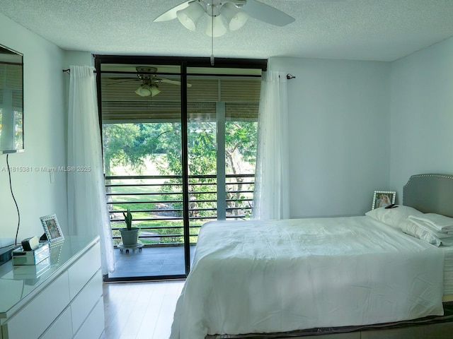 7850 W Mcnab Rd Unit 212, Tamarac, FL 33321 - bedroom with a textured ceiling, access to outside, wood finished floors, and a ceiling fan