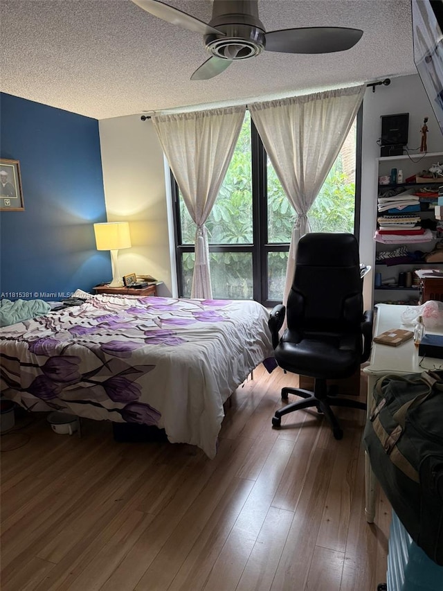 7850 W Mcnab Rd Unit 212, Tamarac, FL 33321 - bedroom with a textured ceiling, hardwood / wood-style flooring, and ceiling fan