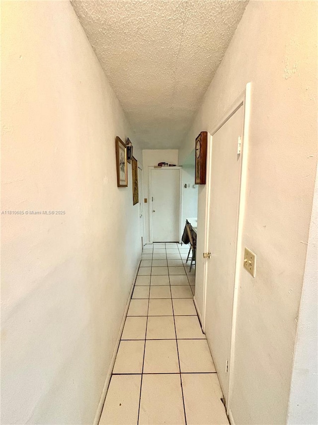 4781 NW 19th Ct, Lauderhill, FL 33313 - corridor with a textured ceiling and light tile patterned flooring