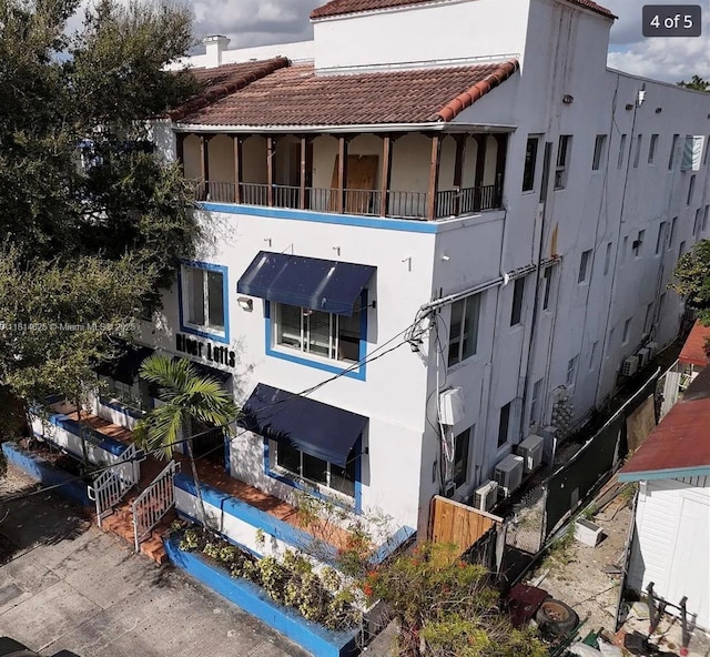 1021 NW 3rd St Unit 306, Miami, FL 33128 - back of property featuring a tiled roof and stucco siding
