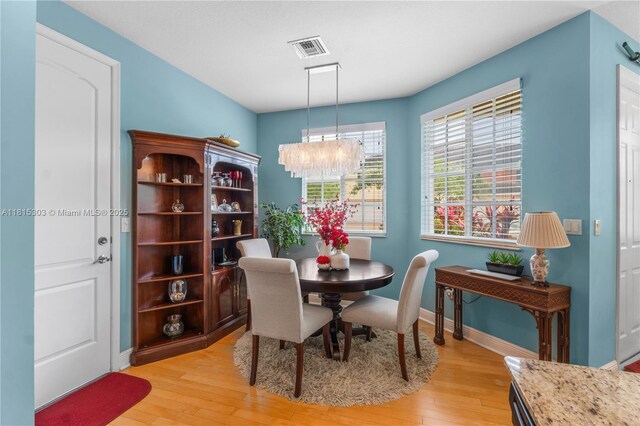 7702 Paddock Pl, Davie, FL 33328 - dining area featuring a chandelier and light wood-style flooring