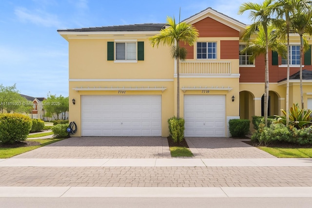 7702 Paddock Pl, Davie, FL 33328 - townhome / multi-family property featuring a garage, driveway, and stucco siding