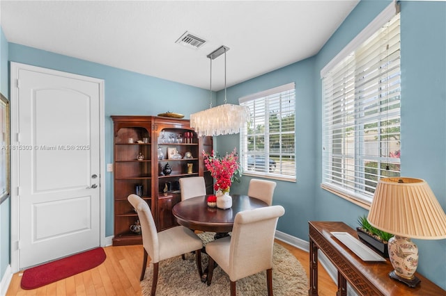 7702 Paddock Pl, Davie, FL 33328 - dining area featuring light wood-type flooring and a chandelier