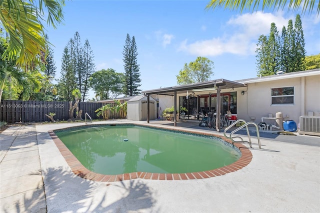 4960 SW 5th St, Margate, FL 33068 - view of swimming pool featuring a patio area, a storage unit, a fenced backyard, and a ceiling fan