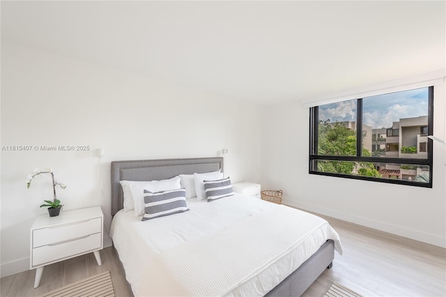 181 Crandon Blvd Unit 306, Key Biscayne, FL 33149 - bedroom with light wood-style floors and baseboards