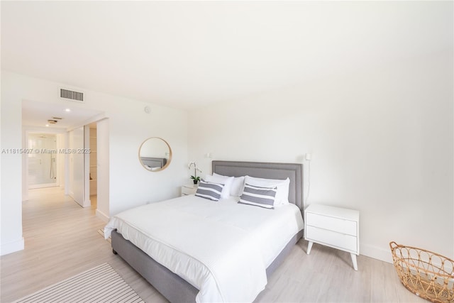 181 Crandon Blvd Unit 306, Key Biscayne, FL 33149 - bedroom with light wood-style floors and baseboards