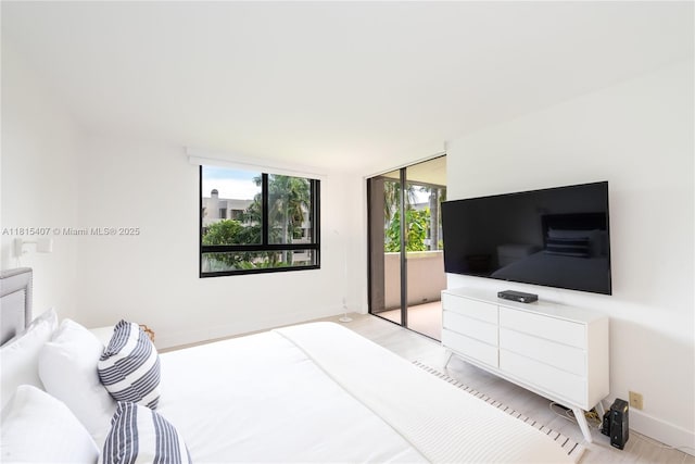 181 Crandon Blvd Unit 306, Key Biscayne, FL 33149 - bedroom with access to exterior and baseboards