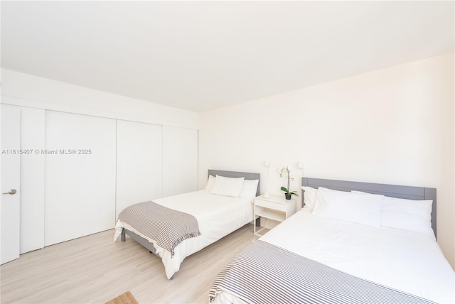181 Crandon Blvd Unit 306, Key Biscayne, FL 33149 - bedroom with light wood-style floors and a closet