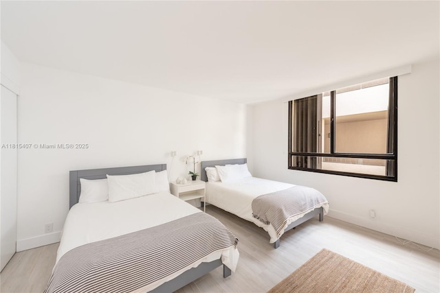 181 Crandon Blvd Unit 306, Key Biscayne, FL 33149 - bedroom featuring wood finished floors and baseboards