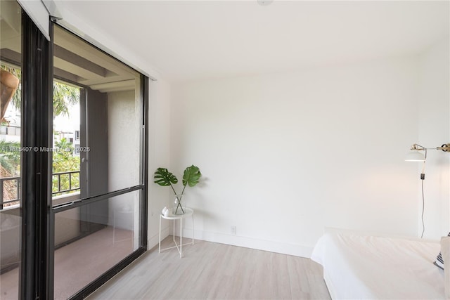 181 Crandon Blvd Unit 306, Key Biscayne, FL 33149 - unfurnished bedroom featuring wood finished floors and baseboards