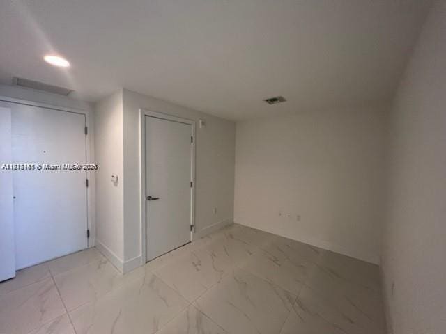 16385 Biscayne Blvd Unit 820, North Miami Beach, FL 33160 - unfurnished room featuring light marble finish floors, recessed lighting, and baseboards