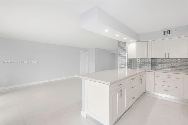 1201 S Ocean Dr Unit 610N, Hollywood, FL 33019 - kitchen with recessed lighting, tasteful backsplash, a peninsula, white cabinetry, and open floor plan