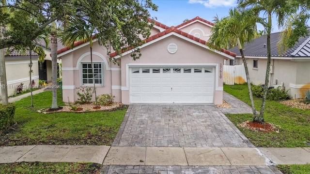 17610 SW 4th Ct, Pembroke Pines, FL 33029 - mediterranean / spanish-style house featuring a garage, stucco siding, driveway, and a tiled roof