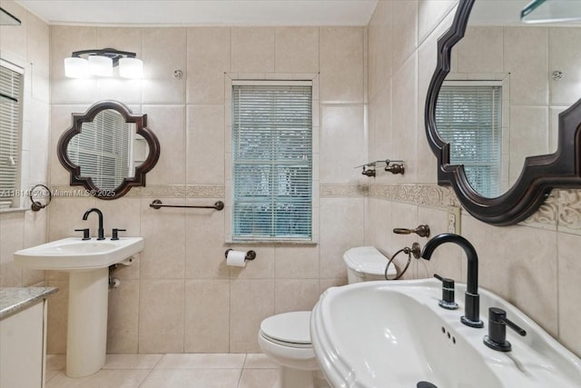 17610 SW 4th Ct, Pembroke Pines, FL 33029 - bathroom with tile walls, toilet, a sink, and tile patterned flooring