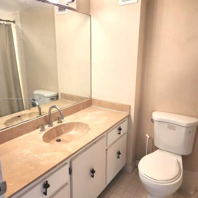 1801 S Flagler Dr Unit 1505, West Palm Beach, FL 33401 - bathroom featuring toilet, vanity, tile patterned flooring, and a shower with shower curtain