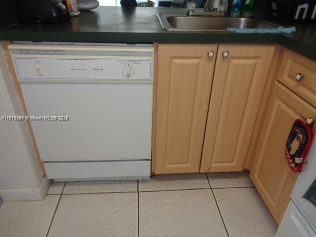 9320 Fontainebleau Blvd Unit 503, Miami, FL 33172 - kitchen with dishwasher, a sink, dark countertops, and light tile patterned flooring