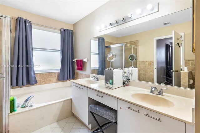 15683 NW 12th Rd, Pembroke Pines, FL 33028 - bathroom with double vanity, a garden tub, a shower stall, tile walls, and tile patterned flooring