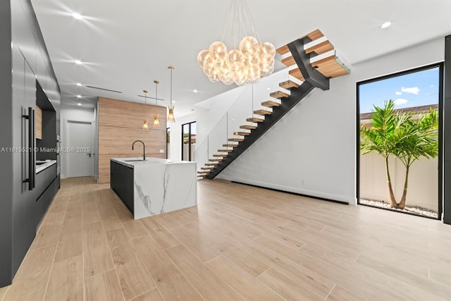 1812 Miami Rd, Fort Lauderdale, FL 33316 - kitchen with modern cabinets, light countertops, pendant lighting, a kitchen island with sink, and light wood-style flooring