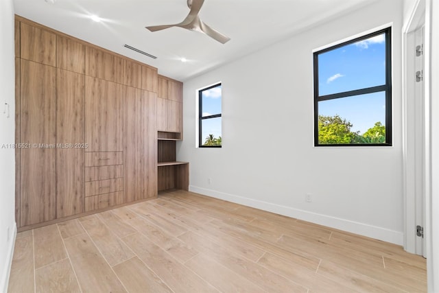 1812 Miami Rd, Fort Lauderdale, FL 33316 - unfurnished bedroom featuring multiple windows, baseboards, light wood-type flooring, and a ceiling fan