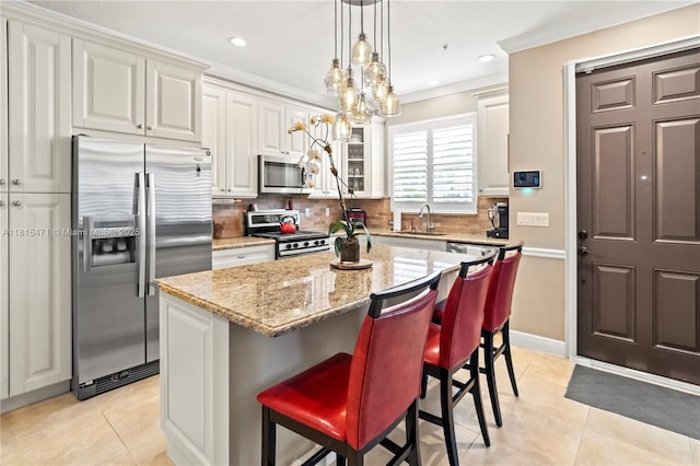 3063 NW 126th Ave, Sunrise, FL 33323 - kitchen featuring stainless steel appliances, light tile patterned flooring, a center island, tasteful backsplash, and light stone countertops