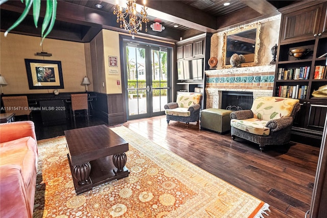 3063 NW 126th Ave, Sunrise, FL 33323 - living room with hardwood / wood-style flooring, french doors, a fireplace, wainscoting, and a chandelier