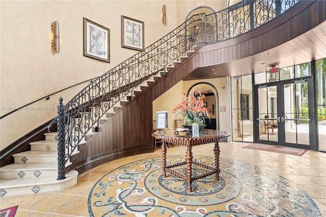 3063 NW 126th Ave, Sunrise, FL 33323 - foyer entrance featuring french doors, a high ceiling, stairs, and stone tile floors