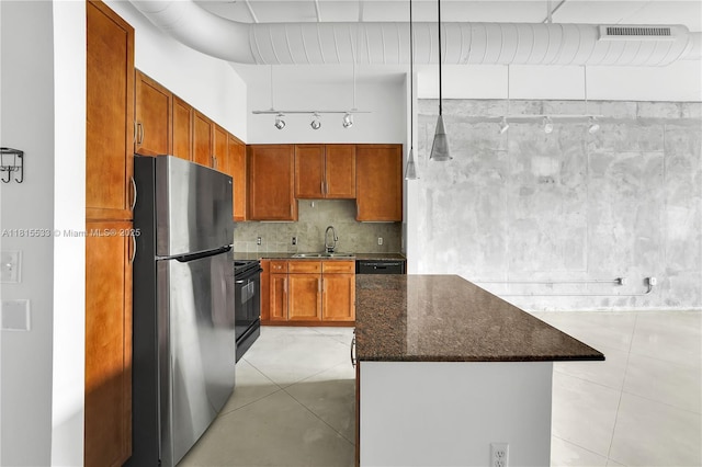 2001 Biscayne Blvd Unit 2305, Miami, FL 33137 - kitchen featuring freestanding refrigerator, a sink, black stove, dark stone countertops, and a kitchen island