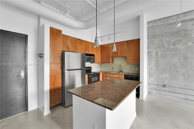 2001 Biscayne Blvd Unit 2305, Miami, FL 33137 - kitchen with black appliances, a sink, brown cabinets, a kitchen island, and hanging light fixtures