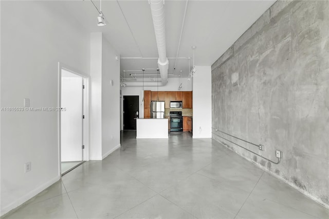 2001 Biscayne Blvd Unit 2305, Miami, FL 33137 - unfurnished living room featuring finished concrete flooring, a towering ceiling, and baseboards