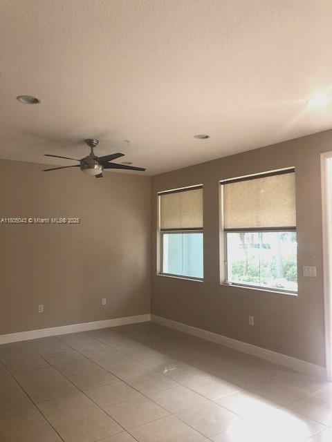 3311 NW 125th Ln, Sunrise, FL 33323 - spare room with ceiling fan, light tile patterned flooring, baseboards, and recessed lighting