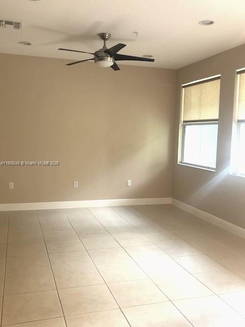 3311 NW 125th Ln, Sunrise, FL 33323 - spare room with a ceiling fan, light tile patterned flooring, and baseboards