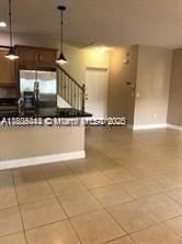 3311 NW 125th Ln, Sunrise, FL 33323 - kitchen with light tile patterned floors, decorative light fixtures, and baseboards