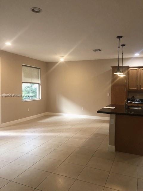 3311 NW 125th Ln, Sunrise, FL 33323 - kitchen featuring dark countertops, light tile patterned flooring, open floor plan, decorative light fixtures, and recessed lighting
